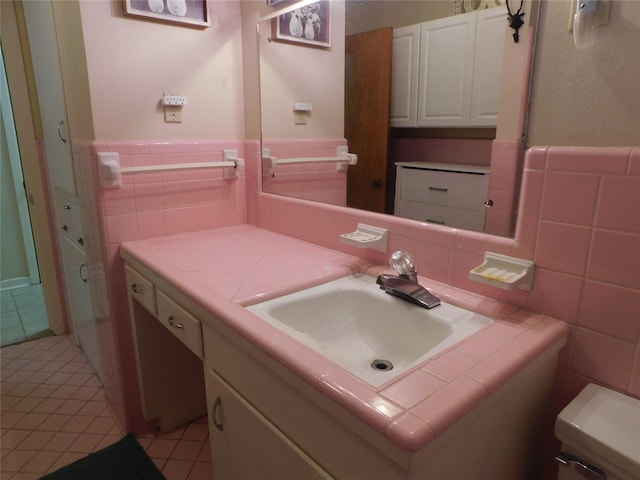 bathroom featuring a wainscoted wall, tile walls, vanity, and tile patterned floors