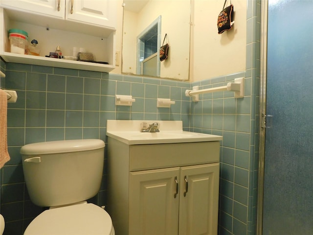 full bath featuring toilet, an enclosed shower, tile walls, and vanity