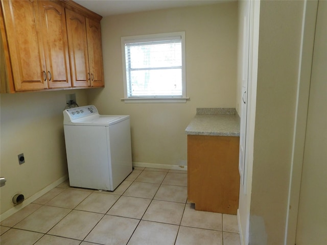 washroom with cabinet space, baseboards, light tile patterned floors, and washer / clothes dryer