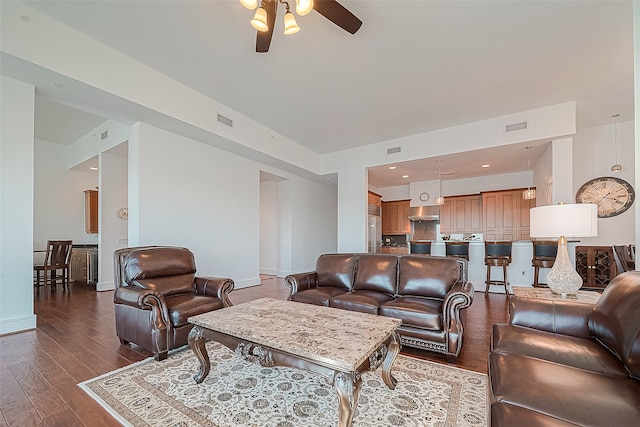 living room featuring ceiling fan and hardwood / wood-style flooring