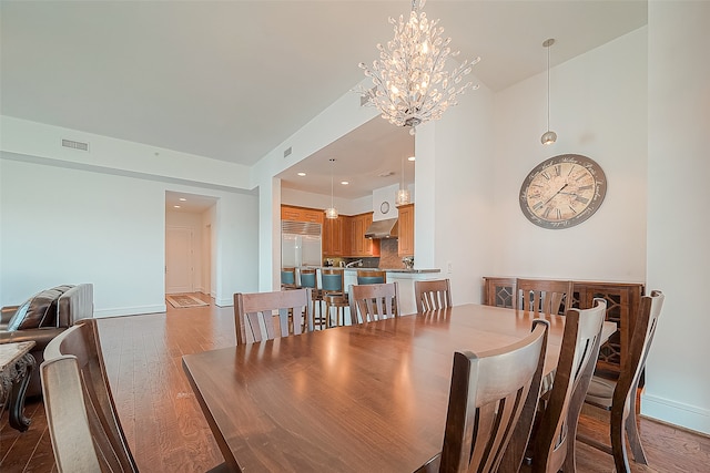 dining space featuring a notable chandelier and dark hardwood / wood-style floors