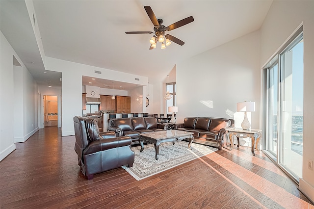 living room with hardwood / wood-style floors, lofted ceiling, ceiling fan, and a healthy amount of sunlight