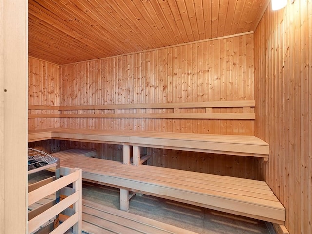 view of sauna / steam room featuring hardwood / wood-style flooring, wood walls, and wood ceiling