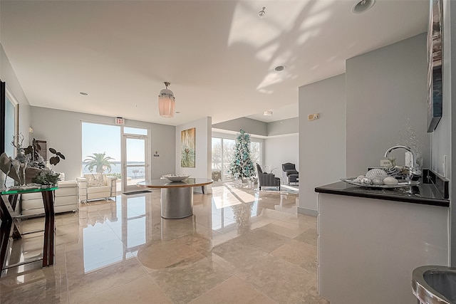 interior space with light tile patterned floors and sink