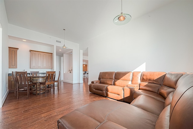 living room featuring dark hardwood / wood-style floors and lofted ceiling