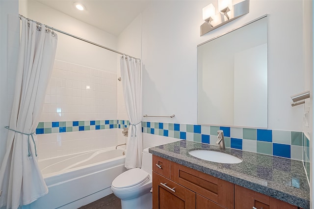 full bathroom with vanity, tasteful backsplash, shower / tub combo, tile walls, and toilet