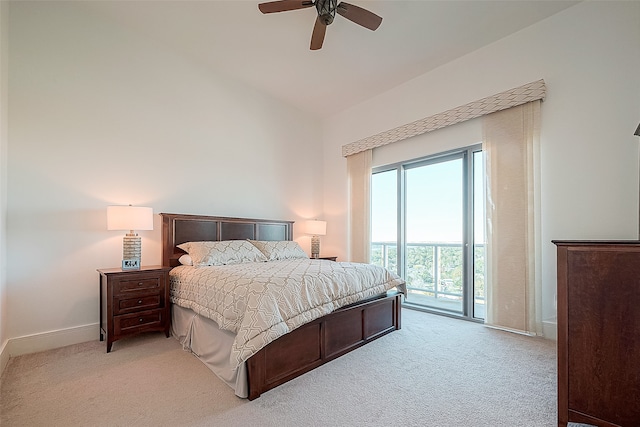 carpeted bedroom featuring ceiling fan, vaulted ceiling, and access to outside