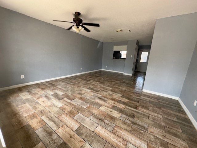 interior space with dark wood-type flooring and ceiling fan