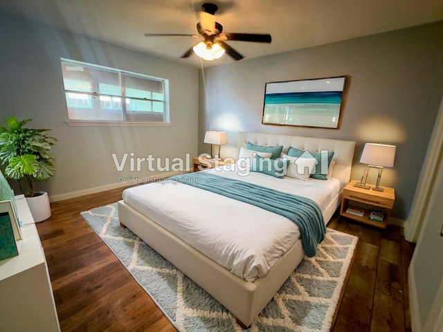 bedroom with dark hardwood / wood-style floors and ceiling fan