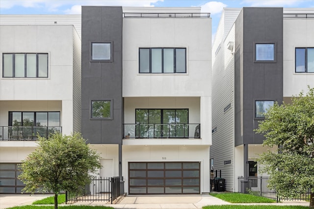 view of front facade featuring a balcony and a garage