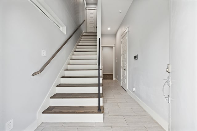 stairway with tile patterned flooring