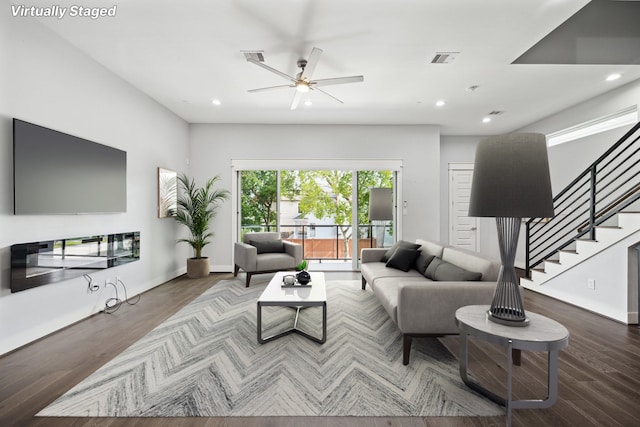 living room with hardwood / wood-style floors and ceiling fan