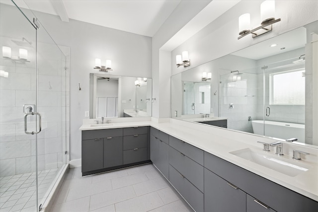 bathroom featuring shower with separate bathtub, vanity, and tile patterned floors