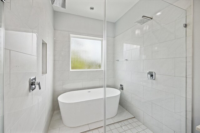 bathroom featuring tile walls, tile patterned flooring, and shower with separate bathtub