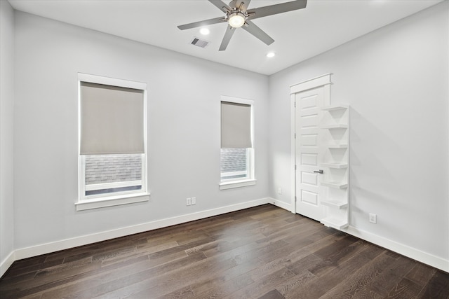 unfurnished bedroom with ceiling fan and dark wood-type flooring