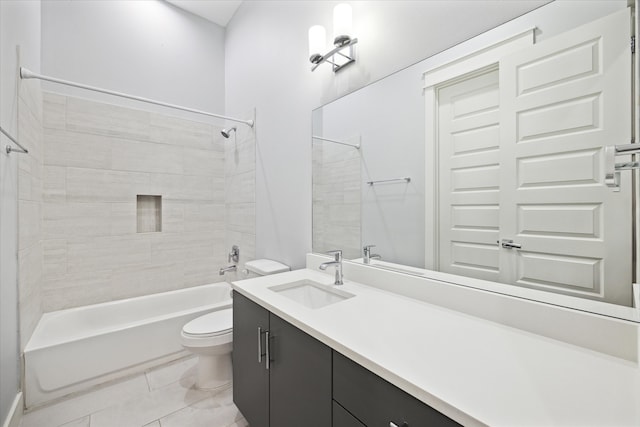 full bathroom with tile patterned flooring, tiled shower / bath, vanity, and toilet