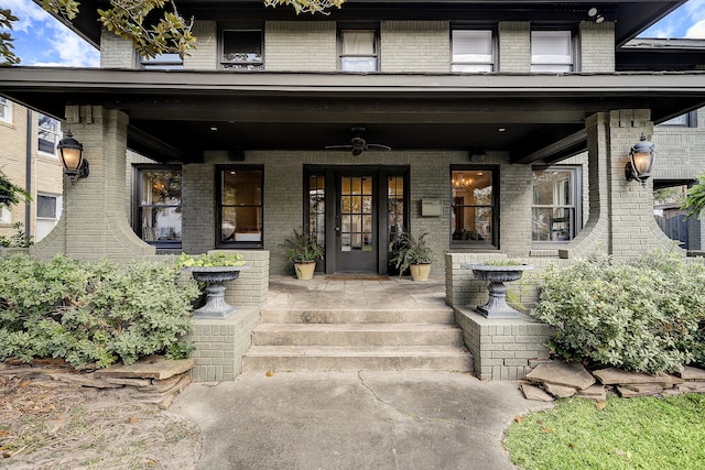 view of exterior entry with ceiling fan