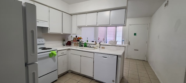 kitchen featuring sink, white appliances, range hood, light tile patterned floors, and white cabinets