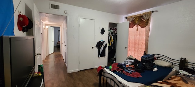 bedroom with a closet and dark hardwood / wood-style flooring