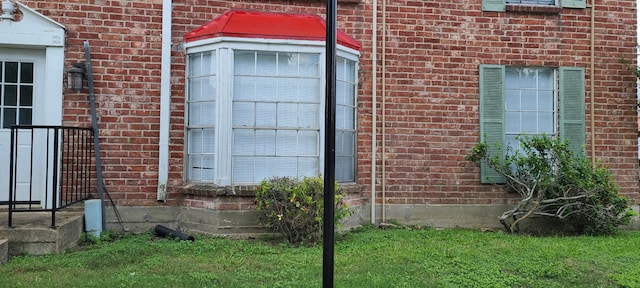 view of side of home with a lawn