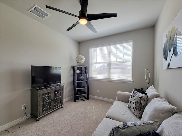 carpeted living room with ceiling fan