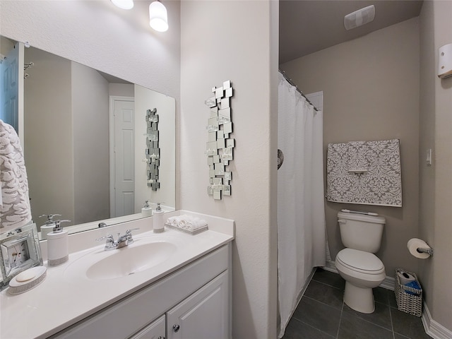 bathroom featuring tile patterned floors, toilet, and vanity