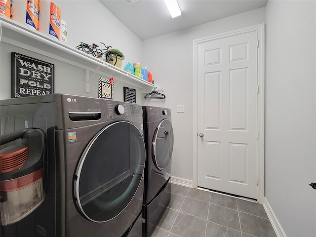 clothes washing area featuring washer and clothes dryer and tile patterned floors