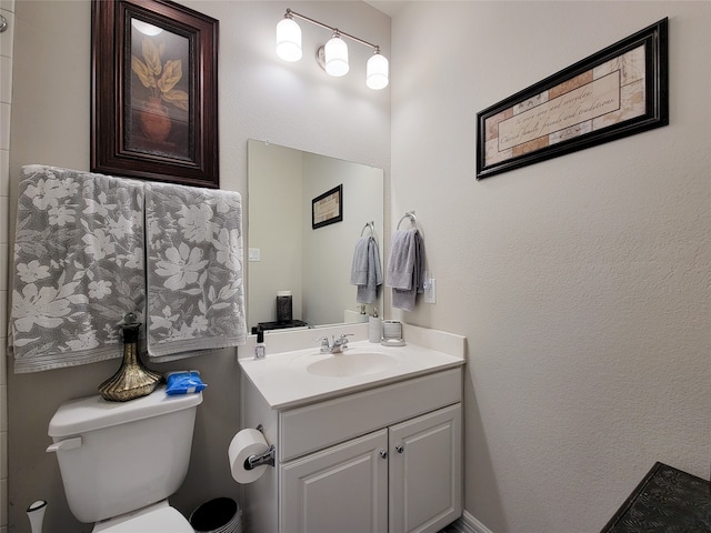 bathroom featuring toilet and vanity