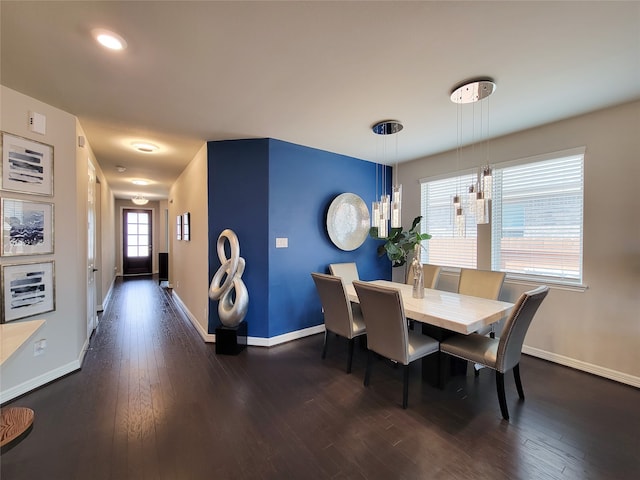 dining space with dark hardwood / wood-style flooring