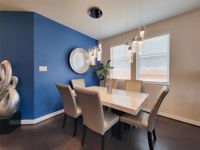 dining room featuring dark wood-type flooring and a chandelier