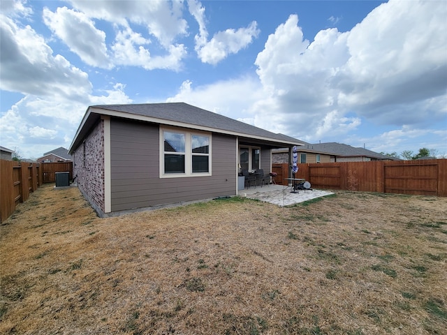 back of property with a patio and a lawn