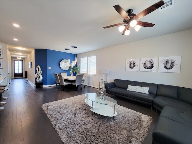 living room with ceiling fan, dark hardwood / wood-style floors, and plenty of natural light