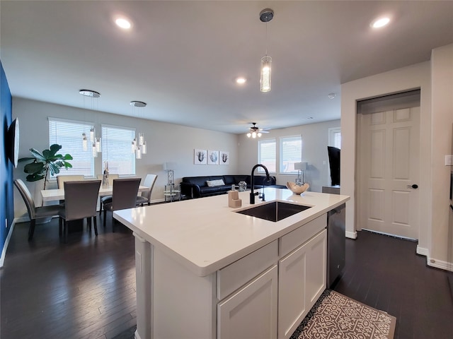 kitchen featuring ceiling fan, dark hardwood / wood-style flooring, white cabinets, sink, and black dishwasher