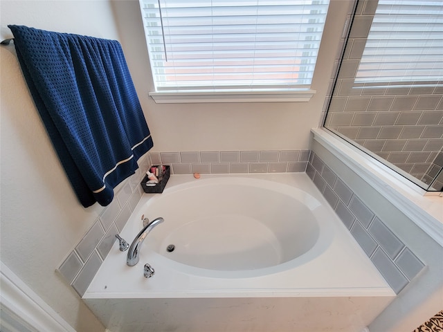 bathroom featuring tiled tub