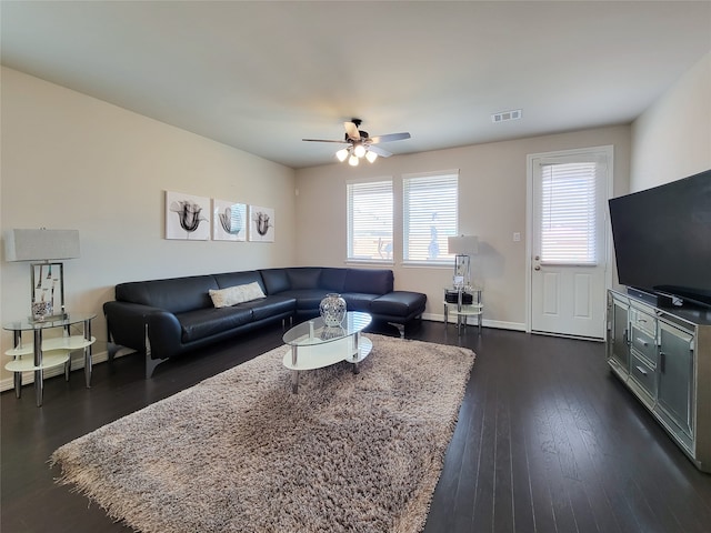 living room featuring ceiling fan and dark wood-type flooring