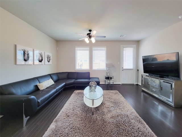 living room with ceiling fan and dark hardwood / wood-style flooring