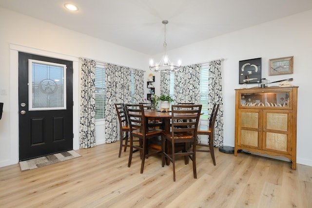 dining space featuring a chandelier, wood finished floors, and recessed lighting