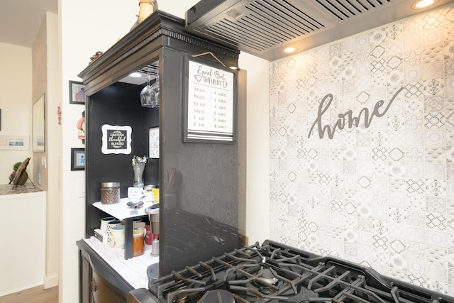 kitchen with stovetop and custom range hood