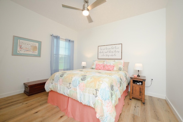 bedroom with a ceiling fan, light wood-type flooring, and baseboards