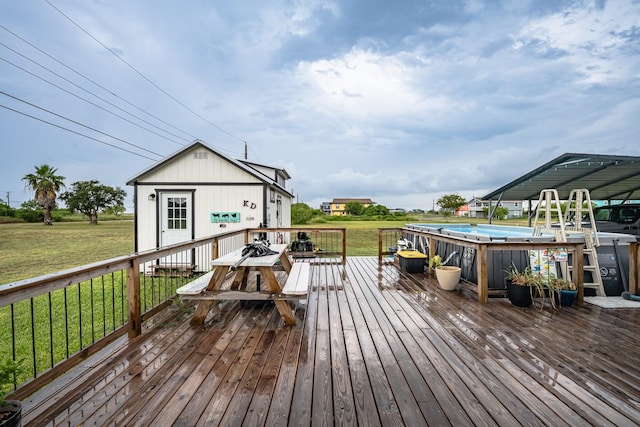 deck with an outdoor pool and a yard