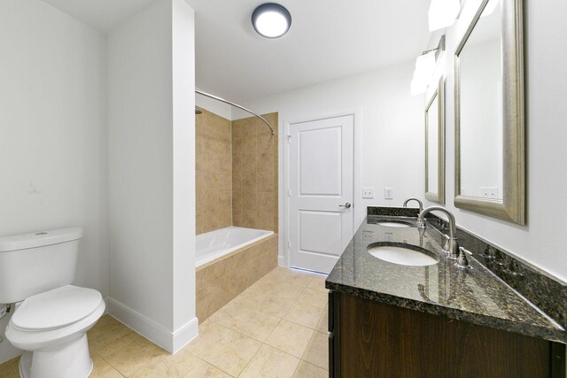 full bathroom featuring tiled shower / bath, toilet, tile patterned floors, and vanity