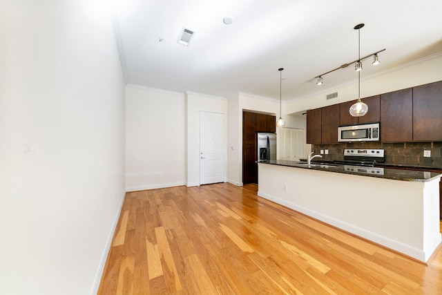 kitchen with backsplash, light hardwood / wood-style floors, dark brown cabinets, range, and track lighting