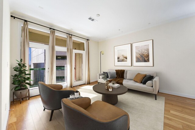 living room featuring light wood-type flooring and ornamental molding