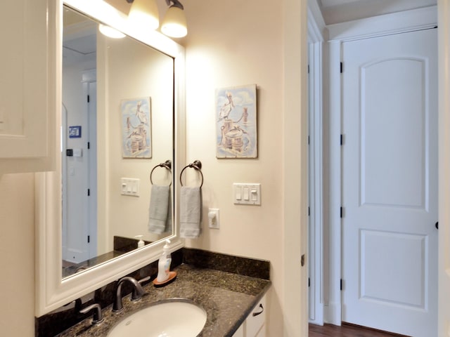 bathroom with hardwood / wood-style flooring and vanity