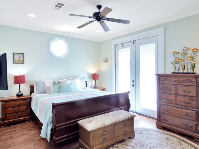 bedroom with ceiling fan, wood-type flooring, ornamental molding, and access to exterior