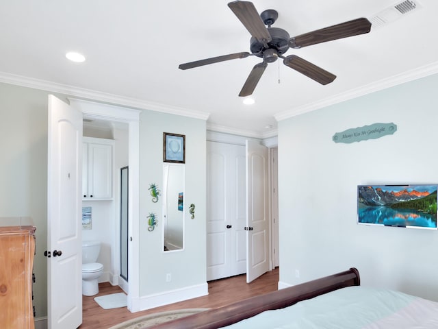 bedroom featuring ceiling fan, wood-type flooring, a closet, ensuite bathroom, and crown molding