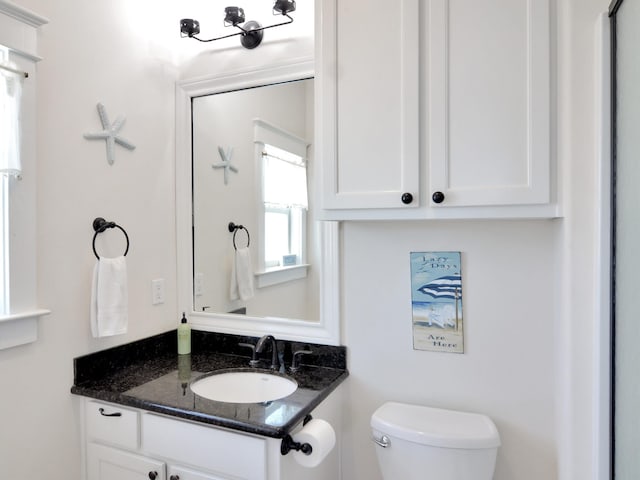 bathroom featuring vanity and toilet