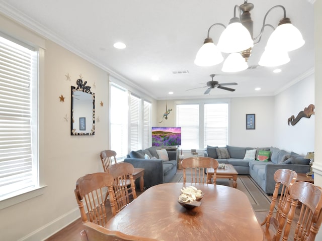 dining room with ceiling fan, hardwood / wood-style floors, and ornamental molding