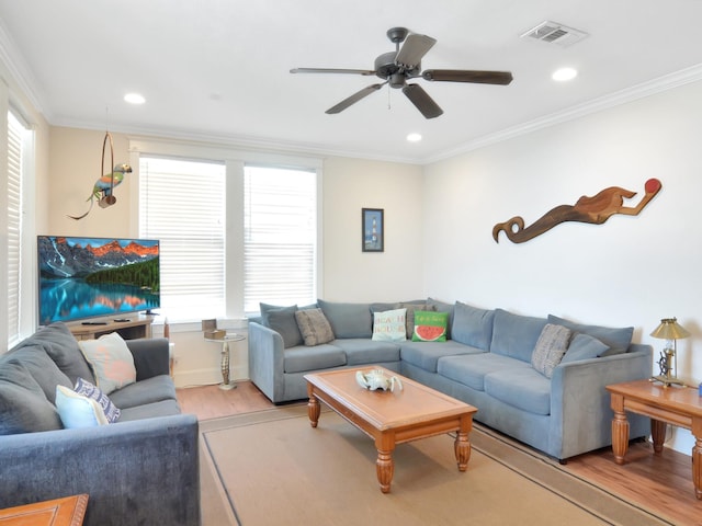 living room featuring ceiling fan, light hardwood / wood-style floors, and ornamental molding