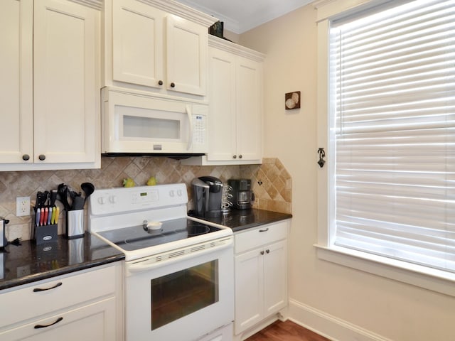 kitchen with hardwood / wood-style floors, ornamental molding, decorative backsplash, white appliances, and white cabinetry